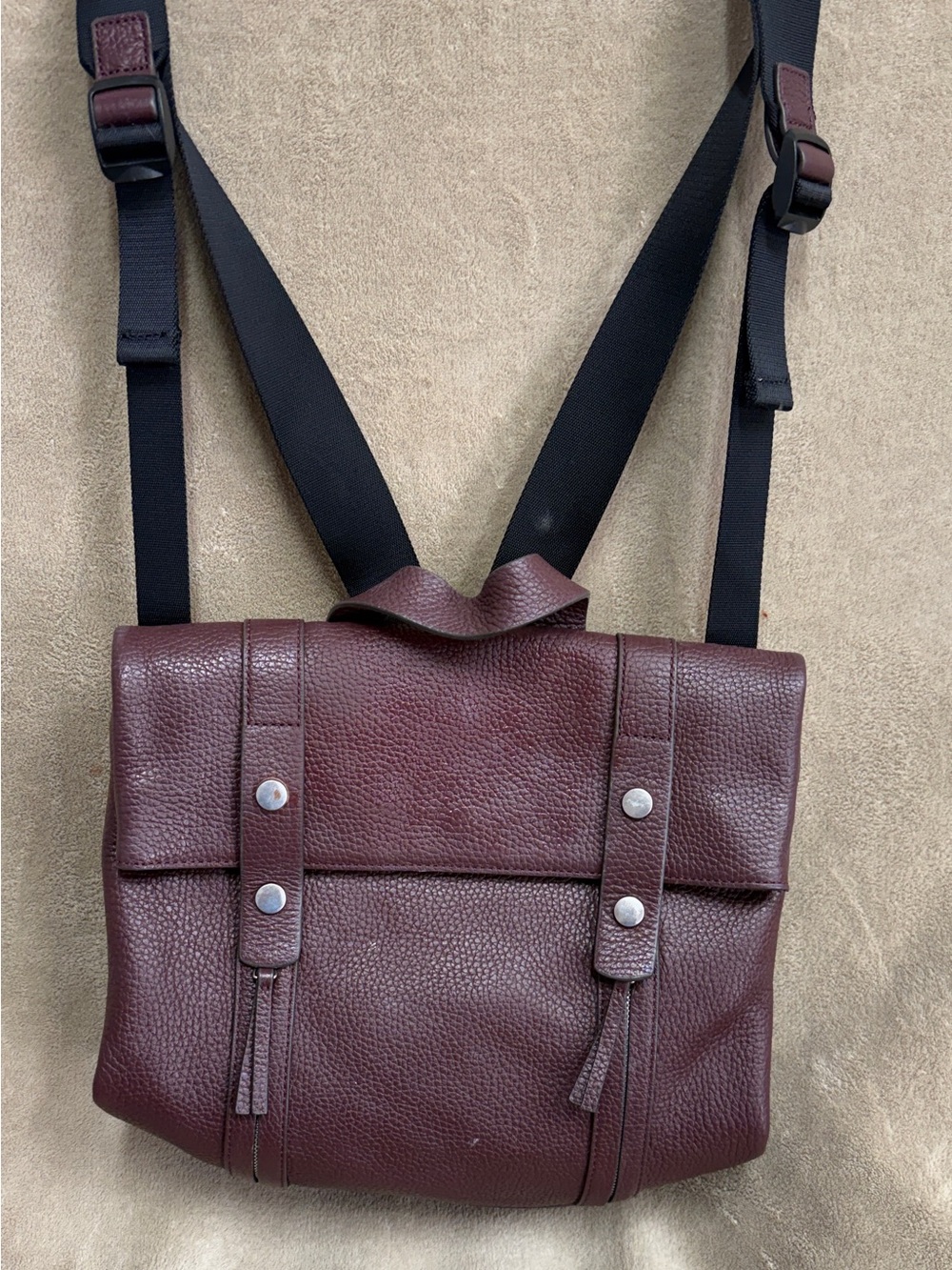 Treasure & Bond Remy pebbled leather backpack in a maroon or burgundy fig color.
